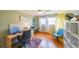 Bright home office with wood floors, white shelving, modern decor, and a blue armchair at 3530 Embry Circle Cir, Atlanta, GA 30341
