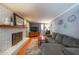 Cozy living room features a white brick fireplace, plush gray sofa, and stylish decor at 3530 Embry Circle Cir, Atlanta, GA 30341