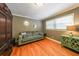 Bright sitting area with love seat, hardwood floors, crown molding, and a large window at 3530 Embry Circle Cir, Atlanta, GA 30341