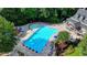 Aerial shot of a large community swimming pool with lounge chairs and umbrellas at 365 Falling Creek Bnd, Duluth, GA 30097