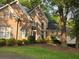 Beautiful brick home with arched window and lush green landscape at 365 Falling Creek Bnd, Duluth, GA 30097