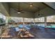 Covered outdoor seating area with picnic tables overlooking a pool at 365 Falling Creek Bnd, Duluth, GA 30097
