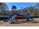 Community playground featuring climbing structures and slides surrounded by lush landscaping at 365 Falling Creek Bnd, Duluth, GA 30097