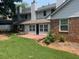 The house features a backyard with a brick patio and lush green lawn at 5950 Wintergreen Rd, Norcross, GA 30093