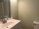 A bathroom features a white vanity with a sink and a toilet at 5950 Wintergreen Rd, Norcross, GA 30093