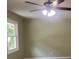 View of a bedroom with a window, ceiling fan and neutral paint at 5950 Wintergreen Rd, Norcross, GA 30093