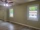 Bedroom with a ceiling fan, two windows and wood-look floors at 5950 Wintergreen Rd, Norcross, GA 30093