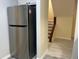 Hallway features stainless refrigerator and access to the stairway at 5950 Wintergreen Rd, Norcross, GA 30093