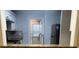 The kitchen offers white cabinets and stainless appliances, with a pass-through to an adjoining room at 5950 Wintergreen Rd, Norcross, GA 30093