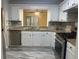 Remodeled kitchen with granite countertops, stainless steel appliances, and white cabinets at 5950 Wintergreen Rd, Norcross, GA 30093