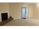 Open living room features a fireplace and access to the outdoors at 5950 Wintergreen Rd, Norcross, GA 30093