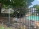 Community pool area with fencing, chairs and lounge spots on a sunny day at 5950 Wintergreen Rd, Norcross, GA 30093