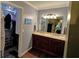 Updated bathroom with a double vanity, wood cabinets, and a walk-in closet at 36 Saint Claire Ne Ln, Atlanta, GA 30324