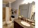 Bathroom featuring granite vanity with a white sink, neutral wall, and shower with tile surround at 36 Saint Claire Ne Ln, Atlanta, GA 30324