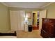 Bedroom with closet and carpet with a bed, a lamp, and a dark colored dresser at 36 Saint Claire Ne Ln, Atlanta, GA 30324