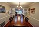 Formal dining room with a large wooden table, chandelier, and french doors at 36 Saint Claire Ne Ln, Atlanta, GA 30324