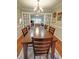 Bright dining room with a wooden table, chandelier, and view into the office area at 36 Saint Claire Ne Ln, Atlanta, GA 30324