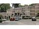 Condominium exterior showcasing multiple units, private entrances, ample parking, and mature trees at 36 Saint Claire Ne Ln, Atlanta, GA 30324
