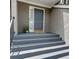 Charming front door entryway with grey door, painted stairs, and stylish potted greenery at 36 Saint Claire Ne Ln, Atlanta, GA 30324