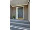 Exterior steps lead to a gray front door with adjacent sidelight window at 36 Saint Claire Ne Ln, Atlanta, GA 30324
