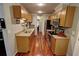 Galley kitchen featuring stainless steel appliances, wooden cabinetry and granite countertops at 36 Saint Claire Ne Ln, Atlanta, GA 30324