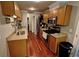 Galley kitchen featuring stainless steel appliances, wooden cabinetry and granite countertops at 36 Saint Claire Ne Ln, Atlanta, GA 30324