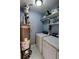 Functional laundry room with a water heater, washing machine, dryer and shelving at 36 Saint Claire Ne Ln, Atlanta, GA 30324