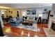 Bright living room featuring hardwood floors, cozy sofas, fireplace, and adjacent dining area at 36 Saint Claire Ne Ln, Atlanta, GA 30324