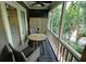 Relaxing screened porch with wooded view, table, chairs, and ceiling fan at 36 Saint Claire Ne Ln, Atlanta, GA 30324