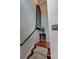 Carpeted staircase with wooden floors, decorative window pane, and charming accent table at 36 Saint Claire Ne Ln, Atlanta, GA 30324