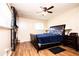 A cozy bedroom featuring a ceiling fan, modern floors, and stylish decor at 3829 Bright Star Road Rd, Douglasville, GA 30135