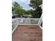 Outdoor balcony boasts wood decking and a white railing with scenic views of community pool and landscape at 704 Olde Mill Ln, Norcross, GA 30093