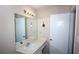 Bright bathroom features a large mirror, vanity with sink, and white door for a clean, simple design at 704 Olde Mill Ln, Norcross, GA 30093
