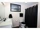 Cozy bathroom featuring a shower with dark curtains, a commode, and a single-sink vanity at 704 Olde Mill Ln, Norcross, GA 30093
