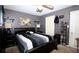 Bedroom with gray walls and a black bed, featuring a ceiling fan and natural light at 704 Olde Mill Ln, Norcross, GA 30093