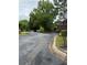 Scenic street view featuring well-maintained roads, lush trees, and landscaping, creating a pleasant community environment at 704 Olde Mill Ln, Norcross, GA 30093