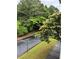 Serene street view surrounded by lush greenery and mature trees, with sidewalk for pedestrians at 704 Olde Mill Ln, Norcross, GA 30093