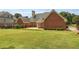 Expansive backyard view of the home's brick facade and spacious lawn at 718 First Cotton Dr, Powder Springs, GA 30127