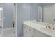 Bathroom with vanity, crystal knobs, mirror and white cabinets at 718 First Cotton Dr, Powder Springs, GA 30127