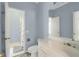 Well-lit bathroom features a toilet, shower, and vanity with a sink at 718 First Cotton Dr, Powder Springs, GA 30127