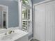 Bathroom featuring tiled floors, vanity with crystal knobs, and natural light at 718 First Cotton Dr, Powder Springs, GA 30127