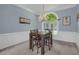 Dining room with chandelier, wainscoting, and a view of outdoor greenery at 718 First Cotton Dr, Powder Springs, GA 30127