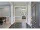 Inviting foyer with marble tile flooring, white trim, and views into multiple living spaces at 718 First Cotton Dr, Powder Springs, GA 30127