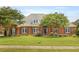Charming brick home featuring a well-manicured lawn, arched entry, and well maintained landscaping at 718 First Cotton Dr, Powder Springs, GA 30127