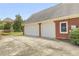 Spacious two-car garage with an adjacent driveway and brick exterior at 718 First Cotton Dr, Powder Springs, GA 30127