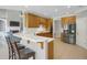 Updated kitchen with stainless steel appliances, breakfast bar, and open to the living room at 718 First Cotton Dr, Powder Springs, GA 30127