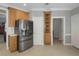 Kitchen featuring stainless steel refrigerator, ample cabinets, and tile flooring at 718 First Cotton Dr, Powder Springs, GA 30127