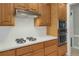 Detailed view of the kitchen showcasing stainless steel appliances, white backsplash, and gas stovetop at 718 First Cotton Dr, Powder Springs, GA 30127