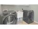 Modern laundry room with Samsung washer and dryer at 718 First Cotton Dr, Powder Springs, GA 30127