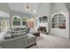 Bright living room featuring vaulted ceiling, large windows, and built in bookshelves and cabinetry at 718 First Cotton Dr, Powder Springs, GA 30127